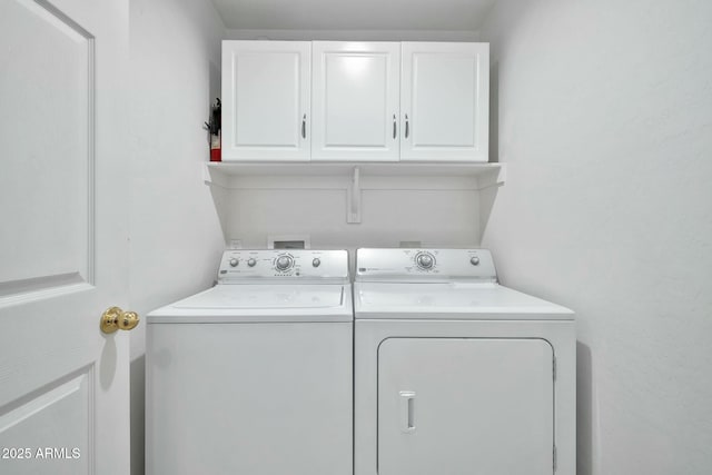 laundry area with cabinets and washer and dryer