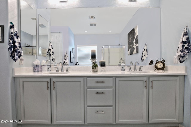 bathroom with an enclosed shower and vanity