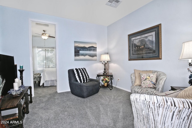 carpeted living room featuring ceiling fan