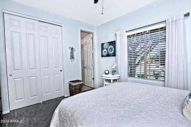 carpeted bedroom with ceiling fan and a closet