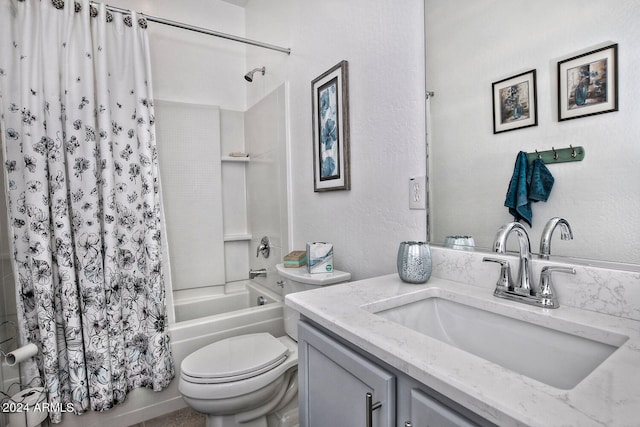 full bathroom with vanity, shower / tub combo, and toilet