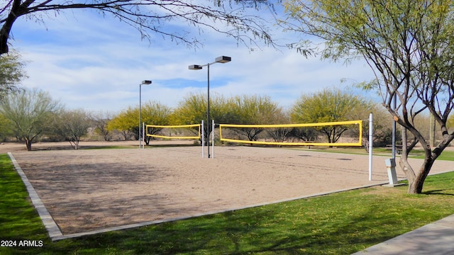 view of property's community featuring a lawn and volleyball court