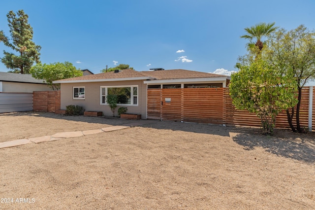 back of property featuring fence