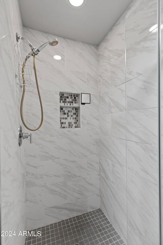 bathroom with a tile shower