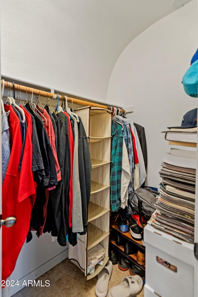 spacious closet with tile patterned flooring and vaulted ceiling