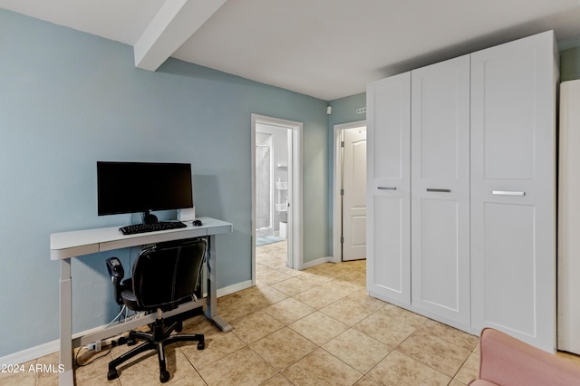 office space with baseboards, beamed ceiling, and light tile patterned floors
