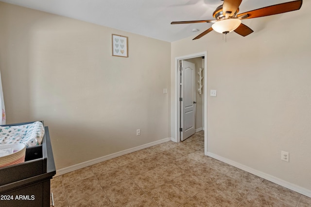 bedroom with light tile patterned floors, baseboards, and ceiling fan