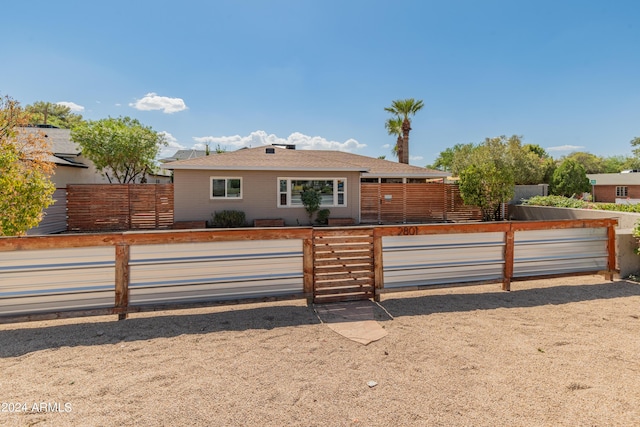 ranch-style home with fence