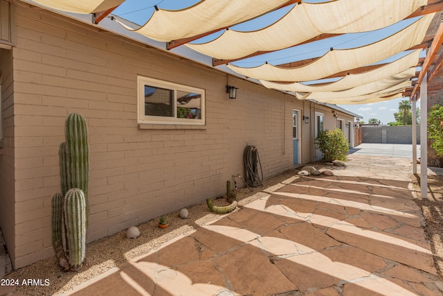 view of side of property with a patio area