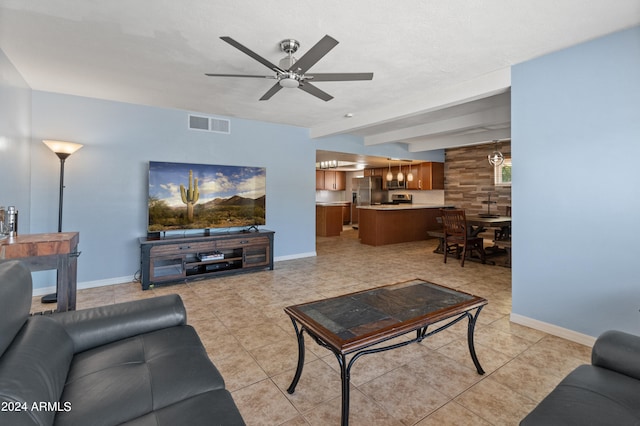 tiled living room featuring ceiling fan and beamed ceiling