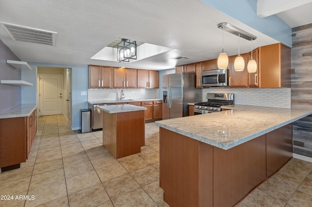 kitchen with tasteful backsplash, kitchen peninsula, stainless steel appliances, light tile patterned floors, and decorative light fixtures