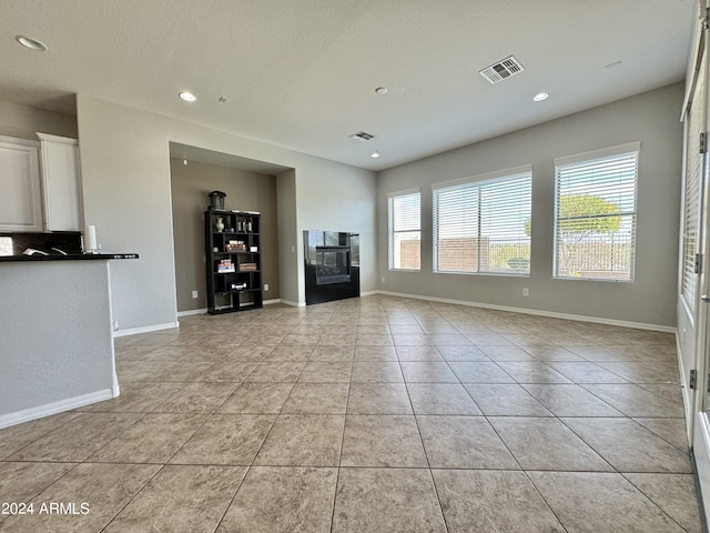 unfurnished living room featuring light tile patterned flooring