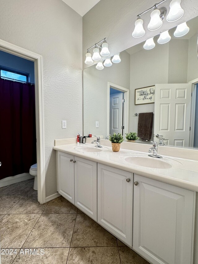 bathroom with tile patterned floors, vanity, and toilet