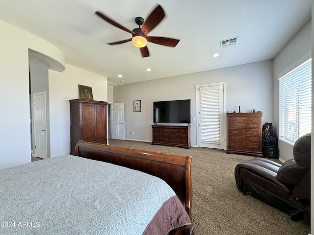 bedroom with ceiling fan and light colored carpet