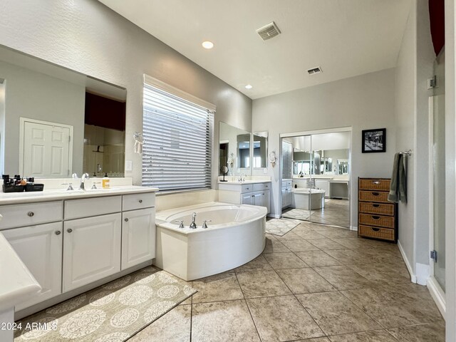 bathroom featuring tile patterned flooring, vanity, and plus walk in shower