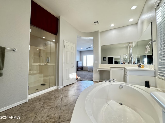 bathroom with tile patterned flooring, vanity, ceiling fan, and plus walk in shower