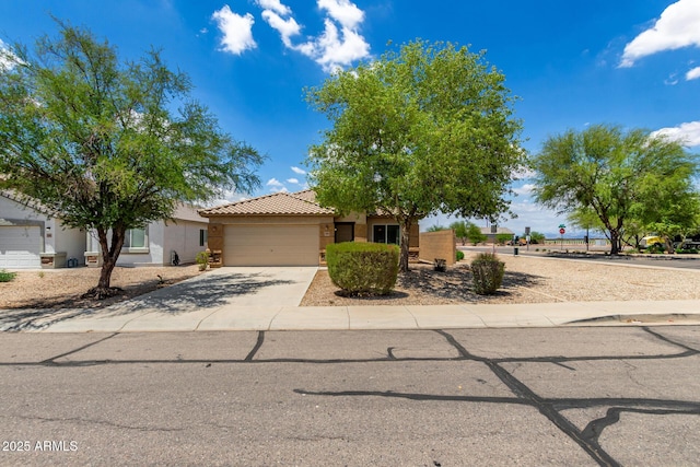 5320 E Silverbell Rd, San Tan Valley, AZ 85143 - obstructed view of property featuring an attached garage, concrete driveway, stucco siding, and a tile roof