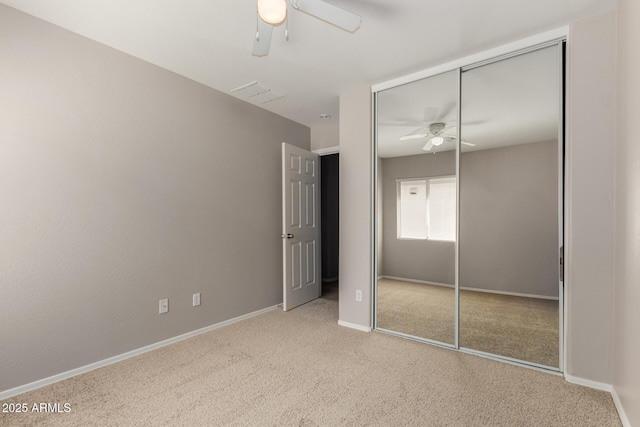 5320 E Silverbell Rd, San Tan Valley, AZ 85143 - unfurnished bedroom with carpet flooring, a closet, baseboards, and a ceiling fan
