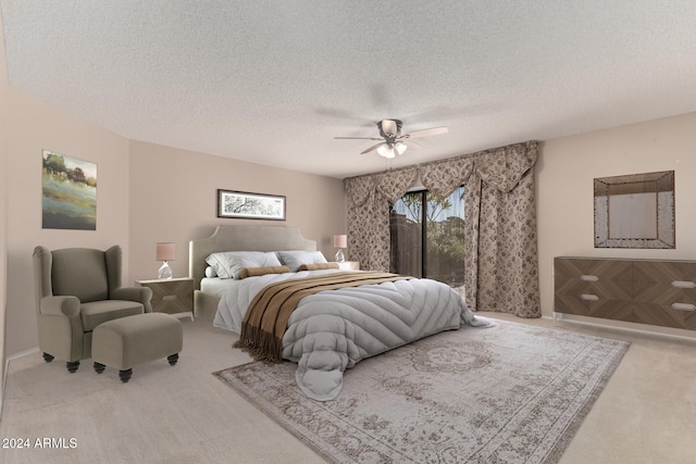 carpeted bedroom with a textured ceiling, multiple windows, and ceiling fan