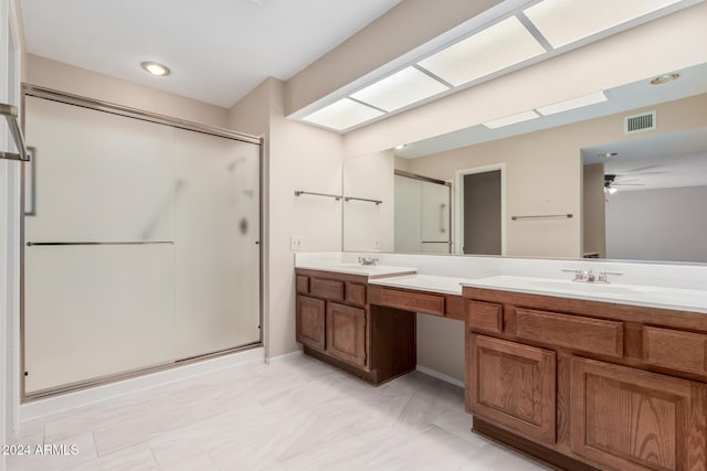 bathroom featuring vanity, ceiling fan, and a shower with shower door