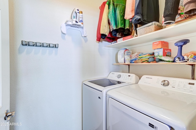 clothes washing area featuring laundry area and washer and dryer