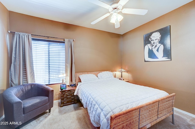 carpeted bedroom with a ceiling fan and baseboards