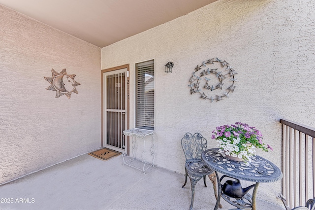 property entrance with a patio area and stucco siding