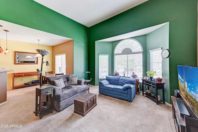 carpeted living area with baseboards