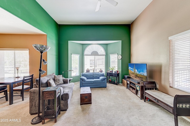 living area with carpet floors and a ceiling fan