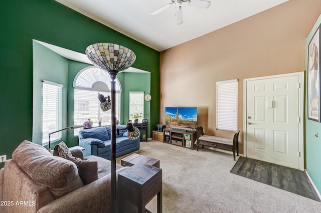 living room featuring a ceiling fan and carpet