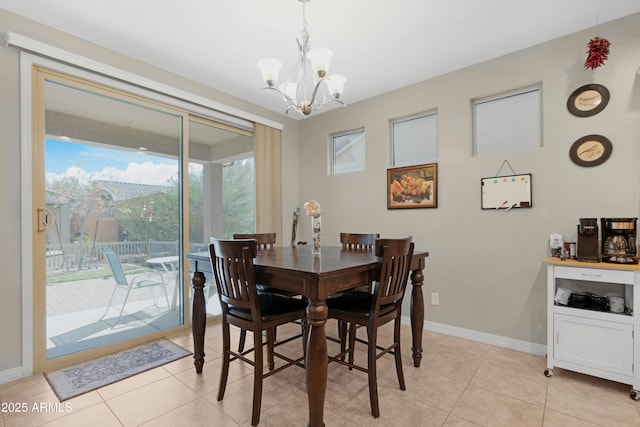 dining space featuring baseboards, light tile patterned floors, and a chandelier
