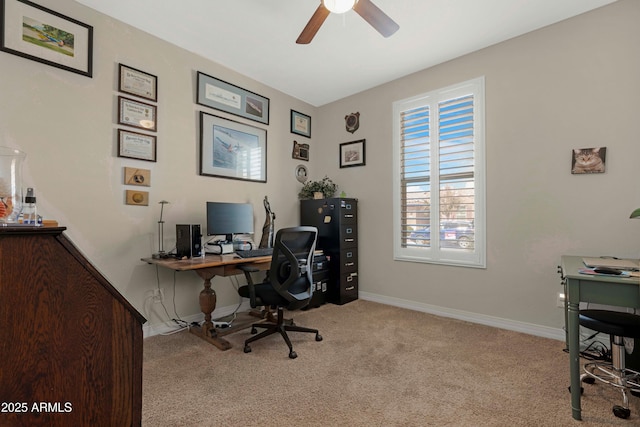 office space featuring carpet floors, ceiling fan, and baseboards