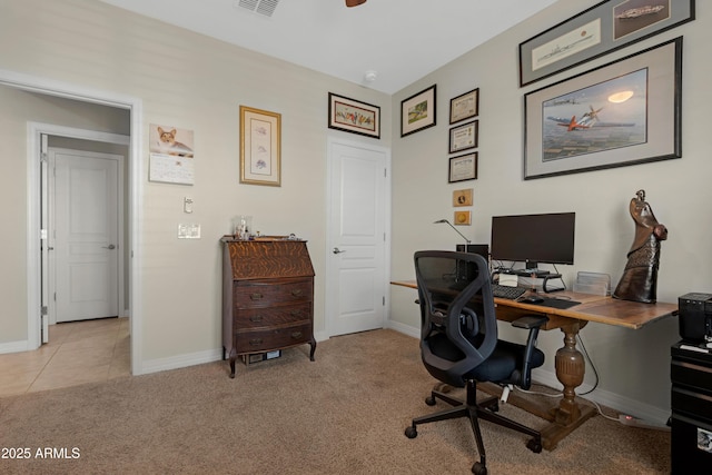 home office featuring baseboards, light colored carpet, and light tile patterned floors