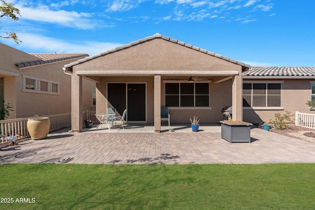 back of house with a patio, ceiling fan, stucco siding, and a tiled roof