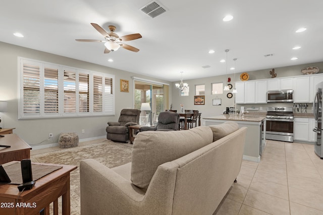 living area with ceiling fan with notable chandelier, recessed lighting, and visible vents