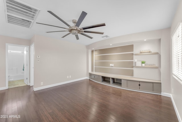 unfurnished living room with baseboards, a ceiling fan, wood finished floors, and visible vents