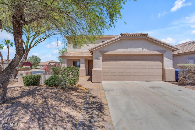 traditional-style house featuring a tiled roof, a garage, stucco siding, and driveway