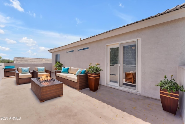 view of patio featuring an outdoor living space with a fire pit