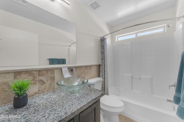 bathroom with vanity, shower / bath combo, toilet, and visible vents