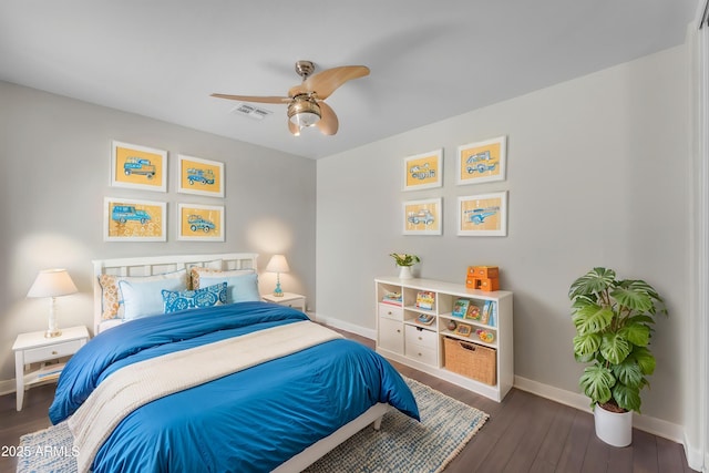 bedroom with baseboards, ceiling fan, wood finished floors, and visible vents