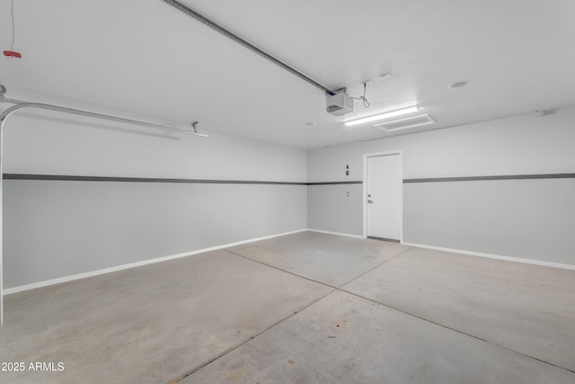 garage with baseboards and a garage door opener