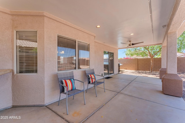 view of patio featuring fence and ceiling fan