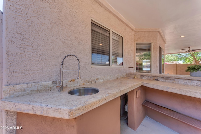 view of patio featuring fence and a sink