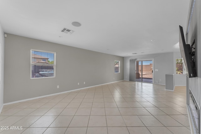 unfurnished room featuring visible vents, baseboards, and light tile patterned floors