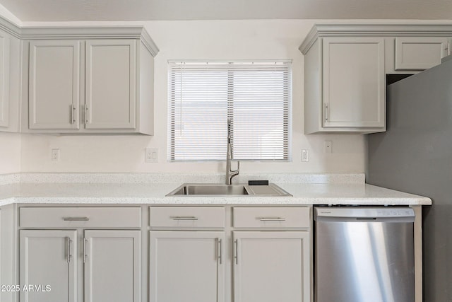 kitchen with gray cabinetry, dishwasher, a sink, and fridge