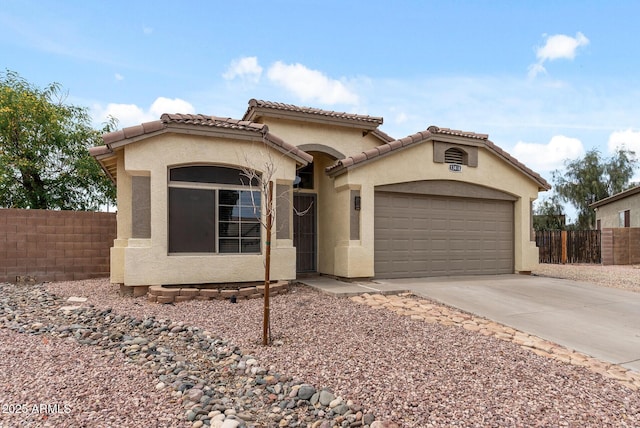 13438 N 130th Ln, El Mirage, AZ 85335 - mediterranean / spanish-style home featuring an attached garage, driveway, stucco siding, and a tiled roof