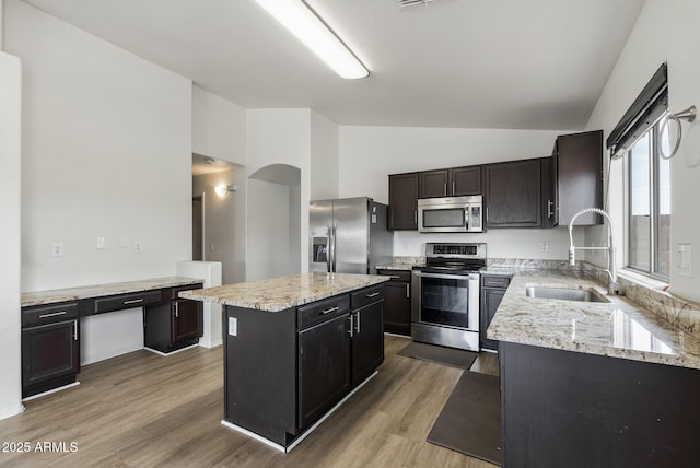 13438 N 130th Ln, El Mirage, AZ 85335 - kitchen featuring appliances with stainless steel finishes, a sink, a kitchen island, wood finished floors, and high vaulted ceiling