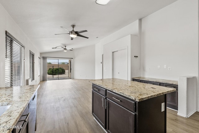 13438 N 130th Ln, El Mirage, AZ 85335 - kitchen featuring a ceiling fan, light wood-type flooring, open floor plan, light stone countertops, and stainless steel dishwasher