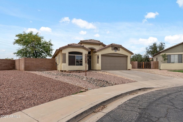 13438 N 130th Ln, El Mirage, AZ 85335 - mediterranean / spanish house with stucco siding, driveway, a tile roof, and a garage
