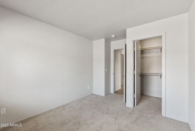 13438 N 130th Ln, El Mirage, AZ 85335 - unfurnished bedroom with carpet, a walk in closet, a closet, and baseboards